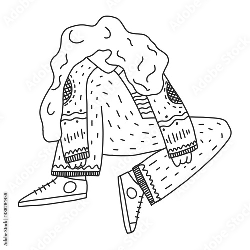 A woman sits on the floor with her head down sadly