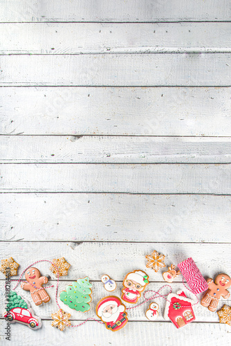 Christmas background with homemade gingerbread cookies. Traditional winter festive baking, Flat lay, white wooden background copy space.