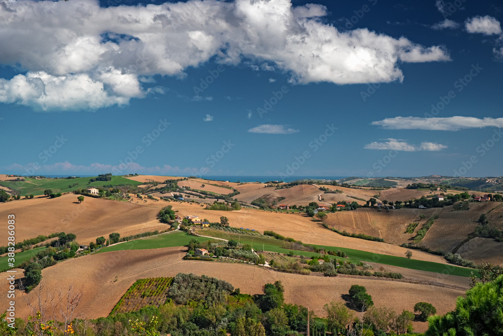 Panoramic view of the gentle cultivated hills of the Marche Apennines in Italy