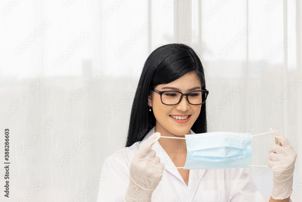 Female doctors wear glasses, masks and rubber gloves to prevent the spread of the coronavirus or COVID-19. Female doctors wear glasses, masks and rubber gloves to prevent the spread of the coronavirus or COVID-19.
