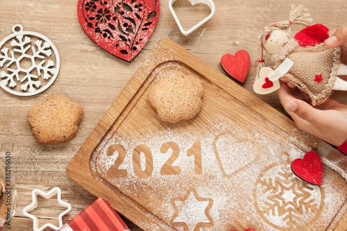 Christmas and New Year 2021 background with ingredients for cooking christmas baking decorated with fir tree. New Year's decor, homemade cookies  preparing for the holiday.