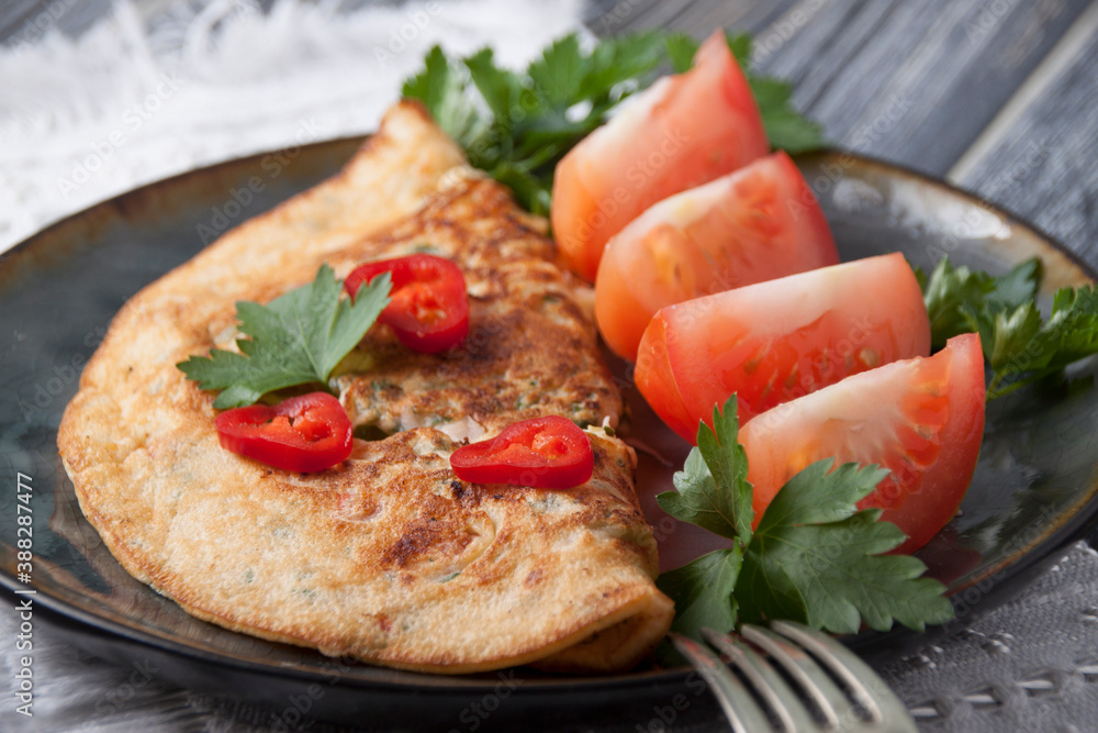 Egg pancake with tomatoes and red pepper