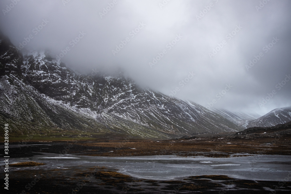 Fog over snow covered mountains in iceland landscape
