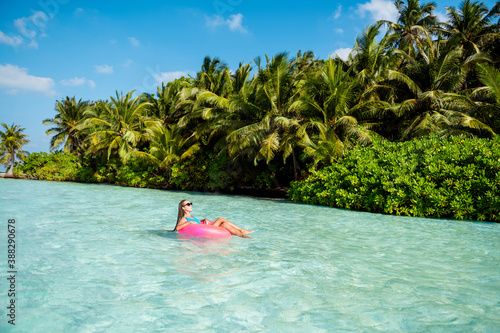 Full body photo of dreamy charming lady tourist enjoy tropical luxury island sun bathing swim azure aqua life buoy wear blue bodysuit sunglass © deagreez