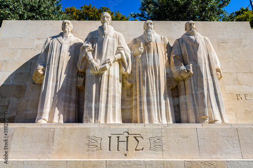 Low angle view of the four statues at the center of the Reformation Wall in the Parc des Bastions in Geneva, Switzerland, representing John Calvin and the Calvinism's main proponents, on a sunny day.