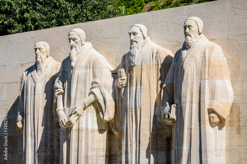 The four statues at the center of the Reformation Wall in the Parc des Bastions in Geneva, Switzerland, representing John Calvin and the Calvinism's main proponents, on a sunny summer day.