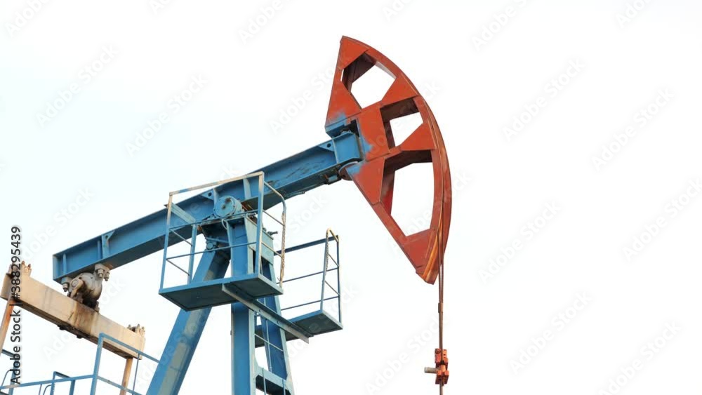 Oil pump jack rocking with pipeline in the background. Rocking machines for power generation, slow motion. Oil pump jack rocking with pipeline in the background. Rocking machines for power generation, slow motion.