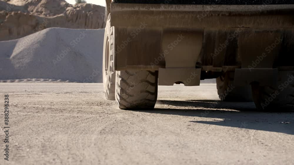 Medium Shot Of A Wheel Loader Moving Forward On A Dusty Road Medium Shot Of A Wheel Loader Moving Forward On A Dusty Road