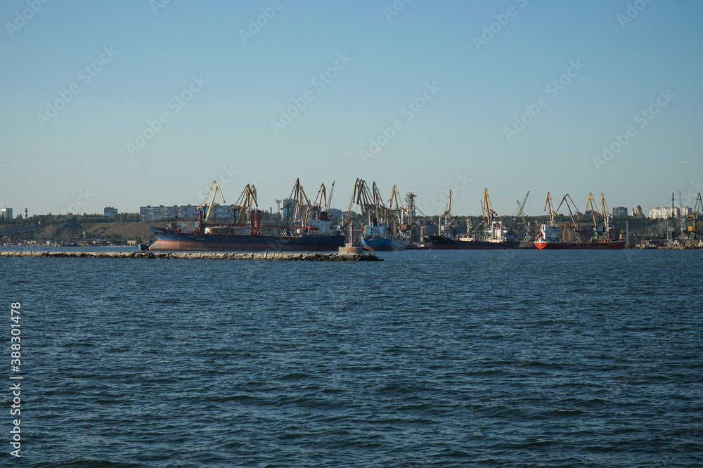 View from afar on cranes and ships in the port of Berdyansk.
