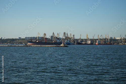 View from afar on cranes and ships in the port of Berdyansk. © ReitNN