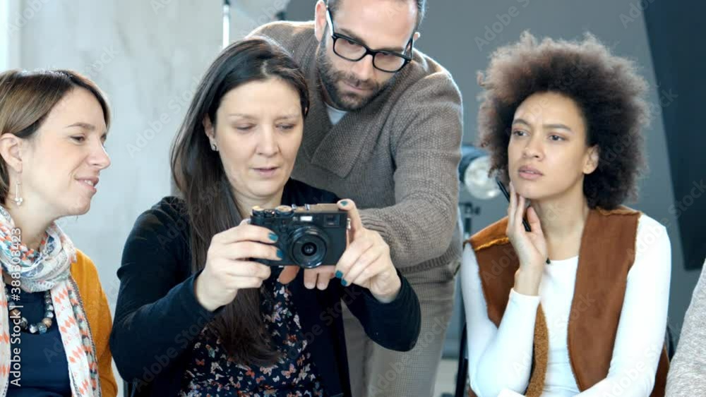 Attendees taking photography lessons from experienced photographer in studio. Attendees taking photography lessons from experienced photographer in studio.