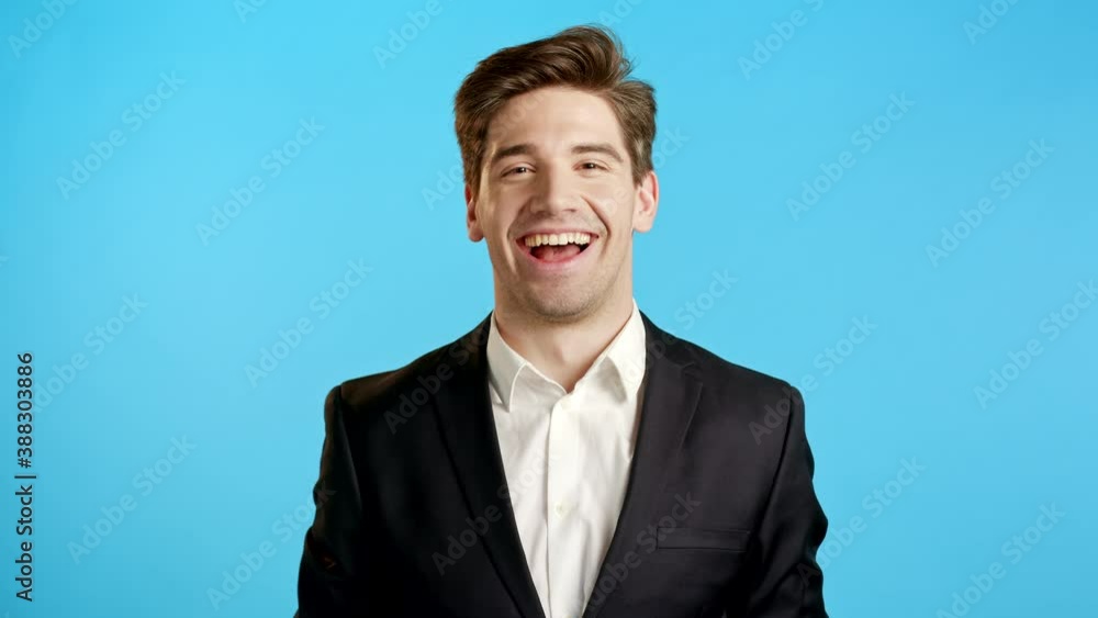 Businessman throwing papers documents into air and celebrates success on blue background. Freedom, successful completion of project concept. Businessman throwing papers documents into air and celebrates success on blue background. Freedom, successful completion of project concept.