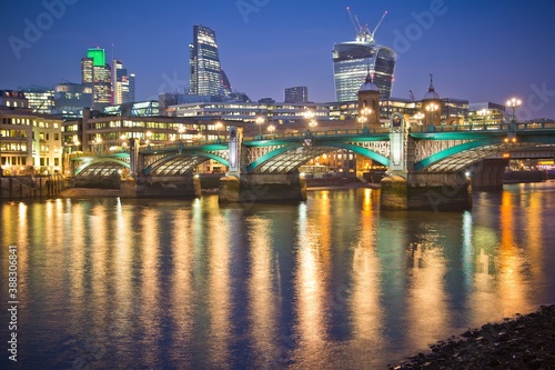 LONDON - MARCH 12 2014: Lit up bridge and cityscape with skyscrapers, 20 Fenchurch Street and Leadenhall, and lights on the Thames river in London. © Алексей Мараховец