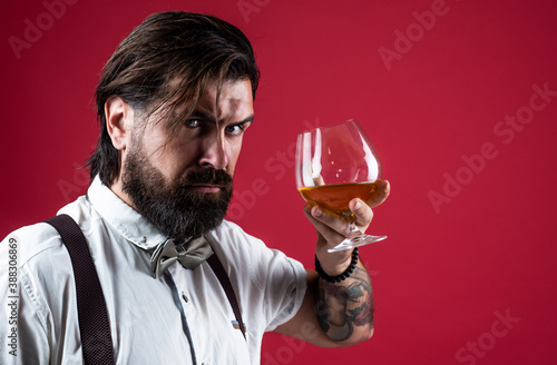 confident bearded man drinking whiskey from glass, bad habit. copy space
