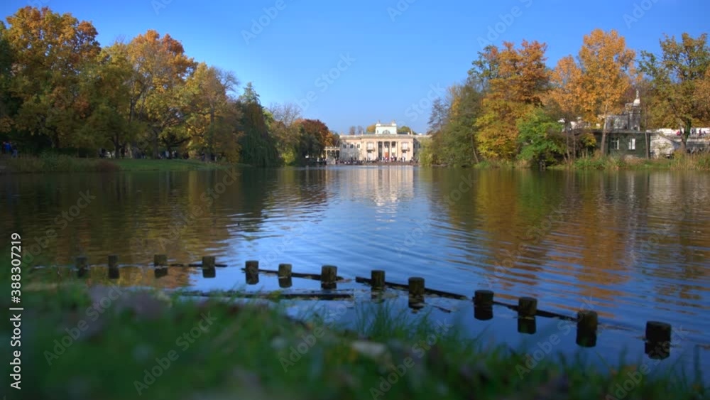 WARSAW, POLAND - OCTOBER 25, 2020: Royal Palace on the Water in Lazienki Park, during autumn afternoon. Lazienki park is the largest park in Warsaw. WARSAW, POLAND - OCTOBER 25, 2020: Royal Palace on the Water in Lazienki Park, during autumn afternoon. Lazienki park is the largest park in Warsaw.