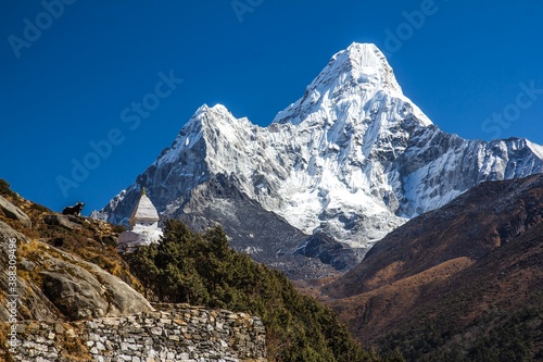 Beautiful Ama Dablam mountain (6812m) covered with snow and  Buddhistic white stupa with eyes is on the left. Himalaya, Nepal.