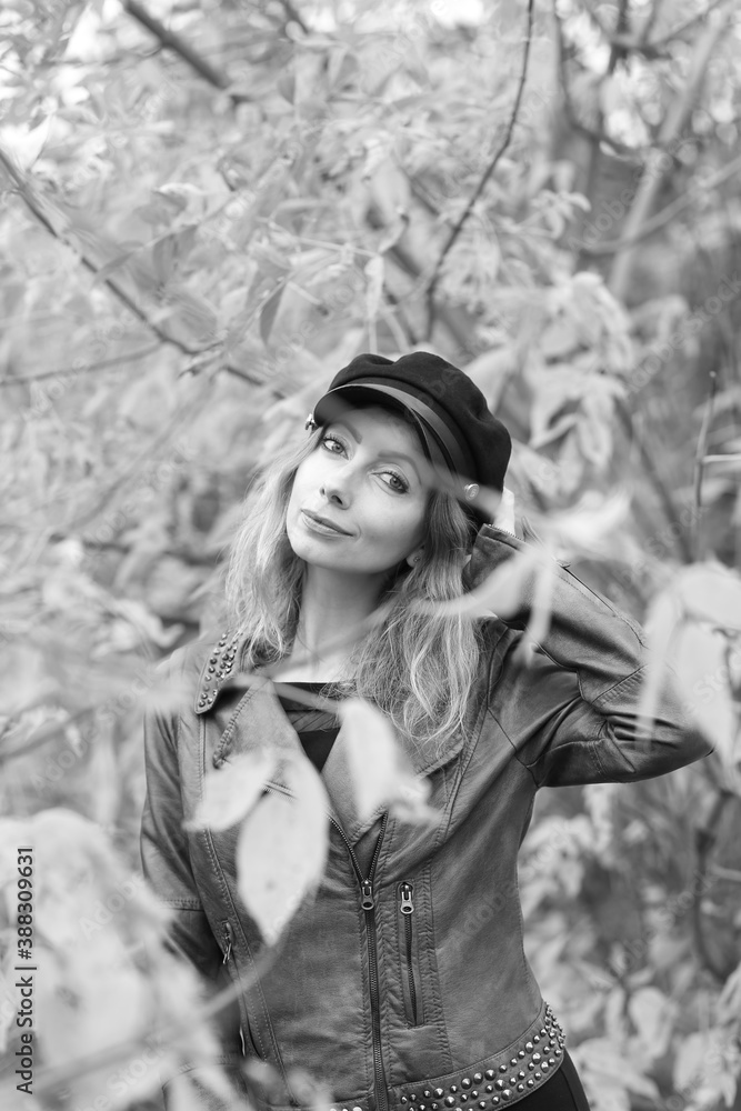 Black and white portrait of woman among leaves in autumn Black and white portrait of woman among leaves in autumn