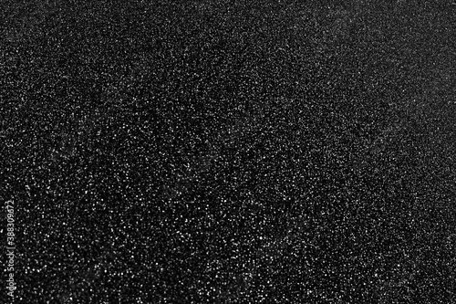 Black glitter bokeh circle glow blurred and blur abstract. Glittering shimmer bright luxury . White and silver glisten twinkle for texture wallpaper and background backdrop. 