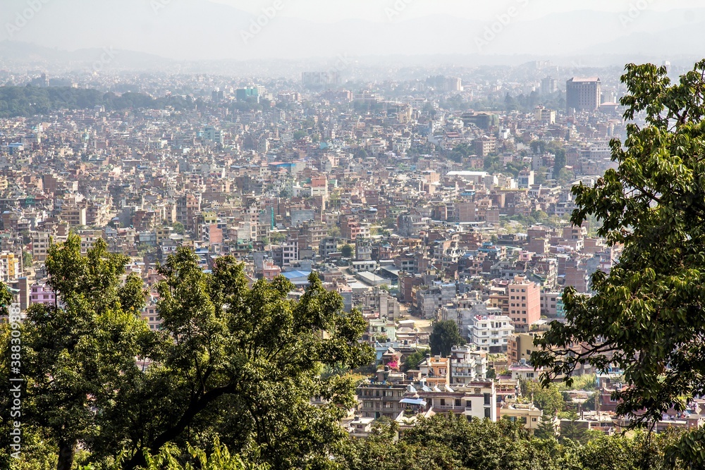 Aerial view of downtown of Kathmandu, Nepal. Many houses and green trees on the foreground. In 2013 KTM was ranked third among top 10 travel destinations on rise in the world.