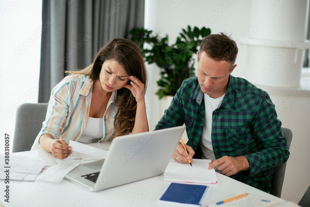 Husband and wife preparing bills to pay. Young couple having financial problems... Husband and wife preparing bills to pay. Young couple having financial problems...