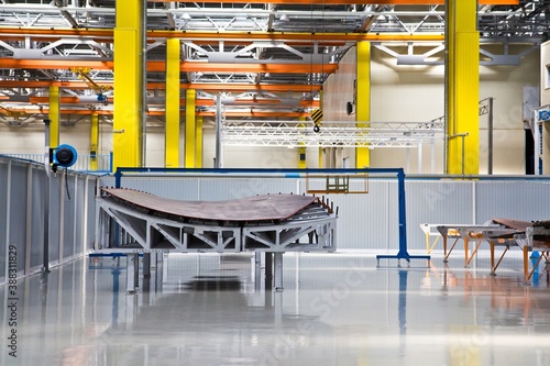 A part of a plane's wing in modern bright colorful assembly hall (shop) in Russia.