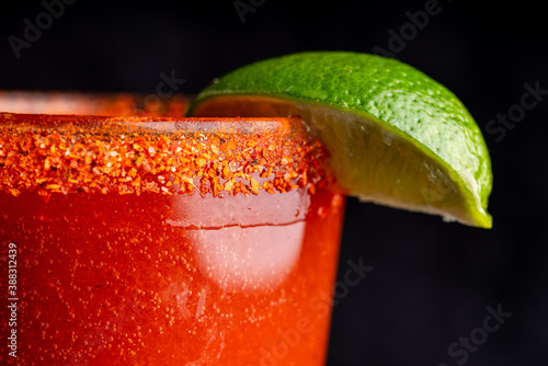 A delicious red cocktail, margarita, bloody mary with tahini and lime.