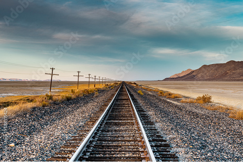 Landscape image of a railroad. Scenic and beautiful. The desert and mountains are nearby.