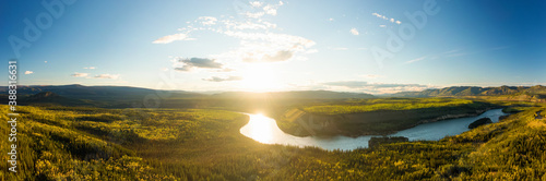 Fotografie Beautiful View of Scenic Valley from Above alongside Winding River, Forest and Mountains at Sunset