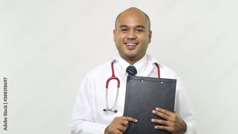 Young asian doctor in uniform put on a stethoscope writing down note on clipboard look into camera on isolated white background. 4K Resolution.
Young asian doctor in uniform put on a stethoscope writing down note on clipboard look into camera on isolated white background. 4K Resolution.