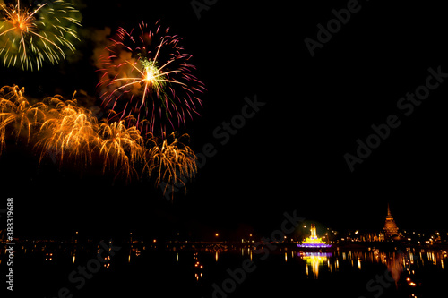 fireworks above the temple and lake with shadow reflex