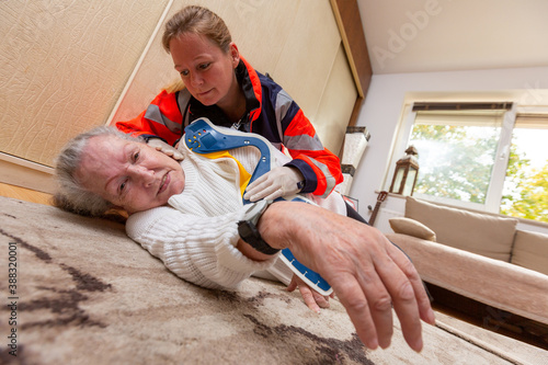 a paramedic attaches a ruff to a fallen lady photo