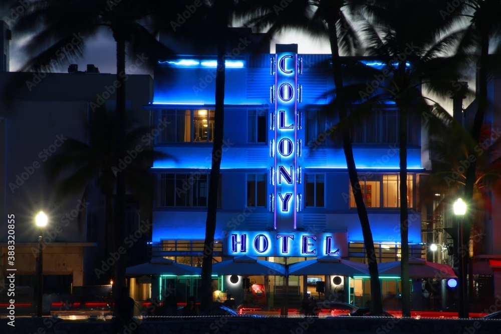 The Colony Hotel is lit up in blue neon flanked by two white lights on  South Ocean Drive and Calle Ocho in Miami Beach, Florida after dusk. Stock  Photo | Adobe Stock
