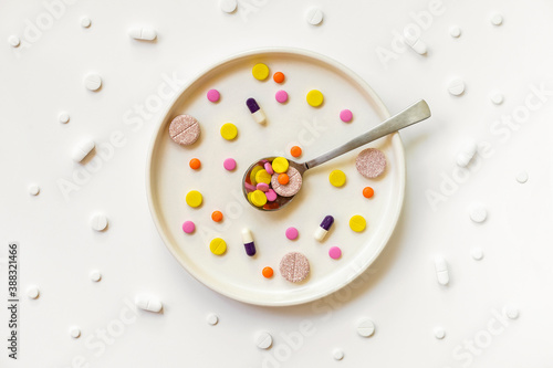 Wallpaper Mural Top view of medicine pills, tablets and different drugs in light plate with spoon. Taking medication, pills instead of food concept Torontodigital.ca