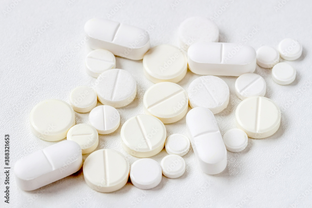 Medical background with light color pills, top view. Concept of health, pharmaceutical industry, medicine, treatment of illness. Medical background with light color pills, top view. Concept of health, pharmaceutical industry, medicine, treatment of illness.