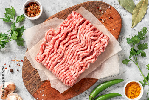 Bilde på lerret Raw uncooked minced pork on a wooden cutting board top view