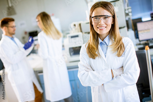 Female scientist in white lab coat standing in the biomedical lab