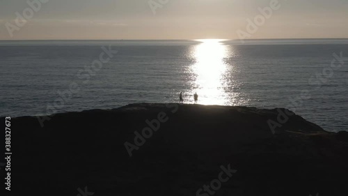 People on Ocean Cliff at Sundown