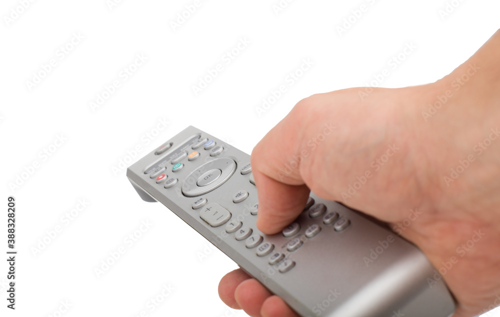 Male hand changing channel with remote control isolated. Hand pressing silver remote control isolated on white background.