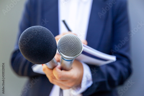 Female journalist or reporter at news conference or media event. Journalism concept.