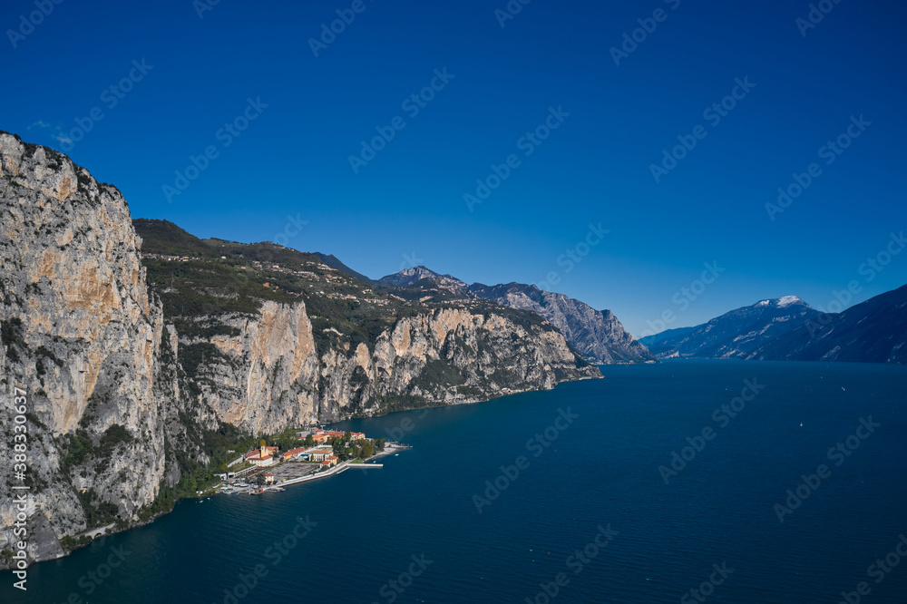 Aerial view at high altitude of the town by the cliff. Town Campione Lake Garda Italy. Panoramic view of the old town of Campione. Italian resort on Lake Garda.