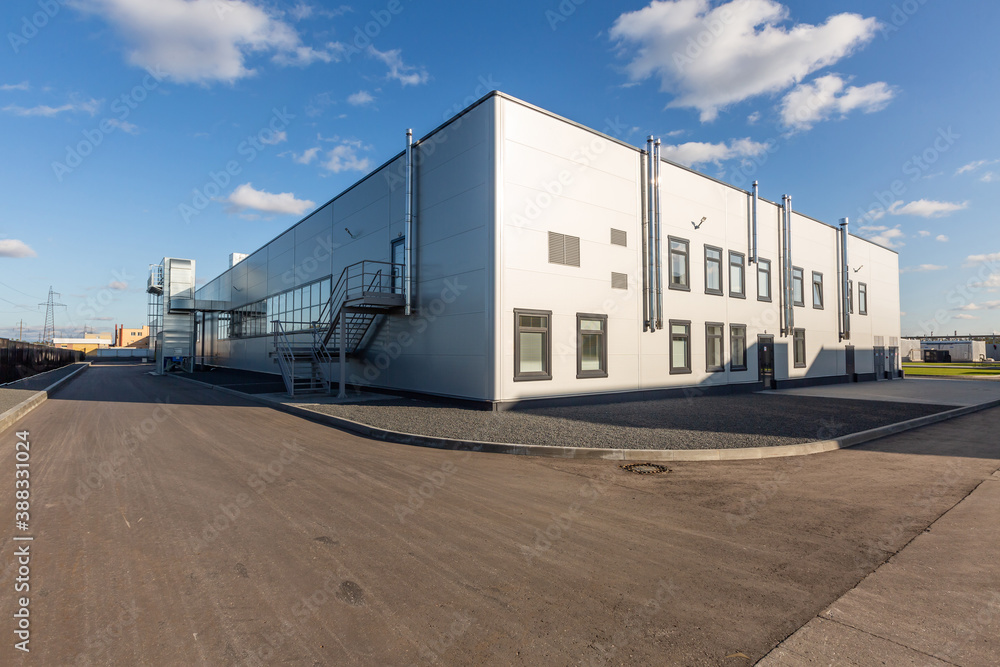Fototapeta premium industrial enterprise appearance. Summer day, blue sky, small metal case
