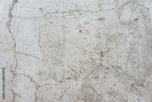 old texture of white gray whitewash street wall in cracks abstract vintage background