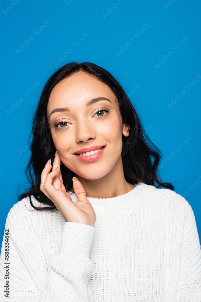 cheerful woman in white knitted sweater smiling isolated on blue cheerful woman in white knitted sweater smiling isolated on blue