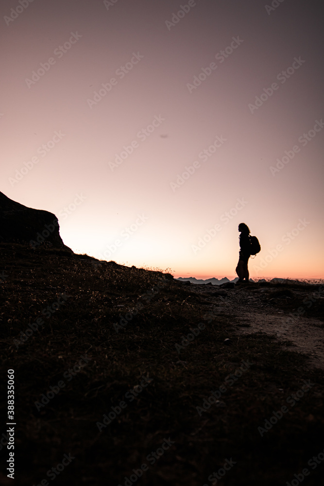 Silhouette of a woman on a swiss rock.