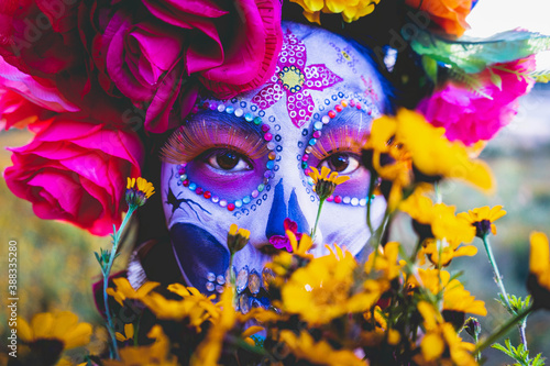 woman with makeup and flowers in front of her photo