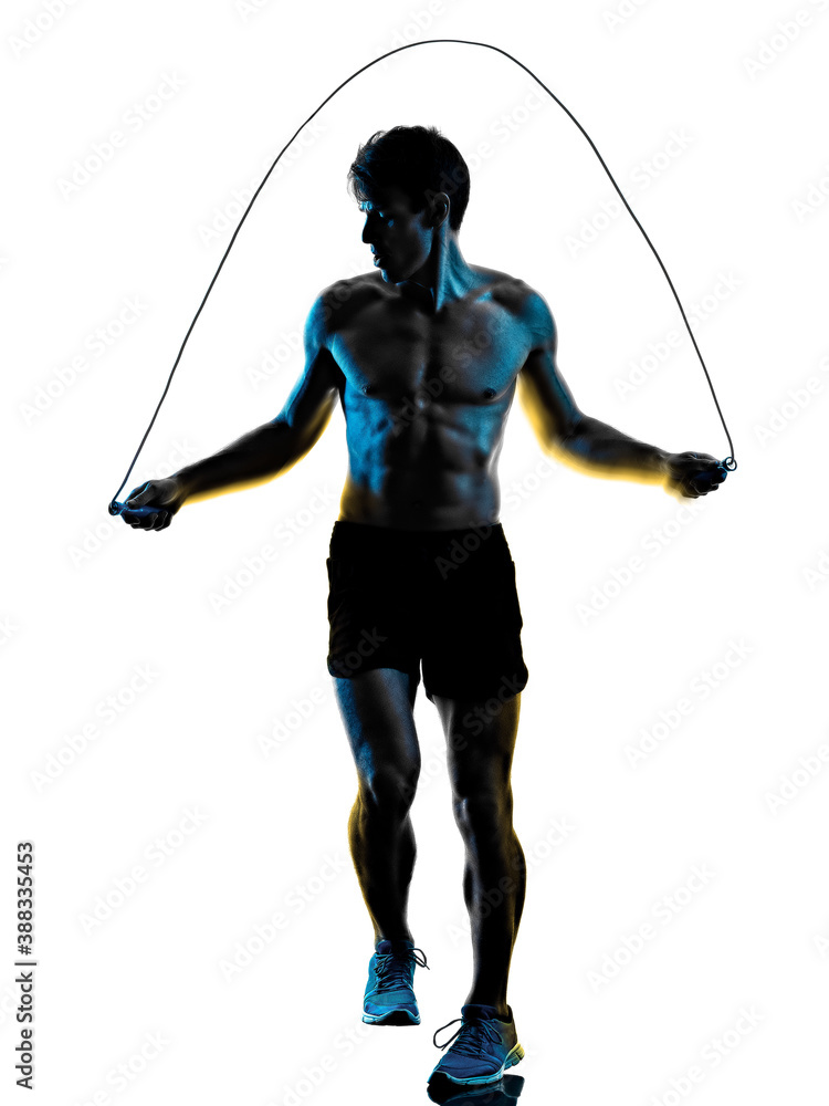 one caucasian young man exercIsing fitness exercise in studio shadow silhouette isolated on white background one caucasian young man exercIsing fitness exercise in studio shadow silhouette isolated on white background