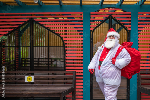 Santa claus in a protective suit during the coronavirus outdoors