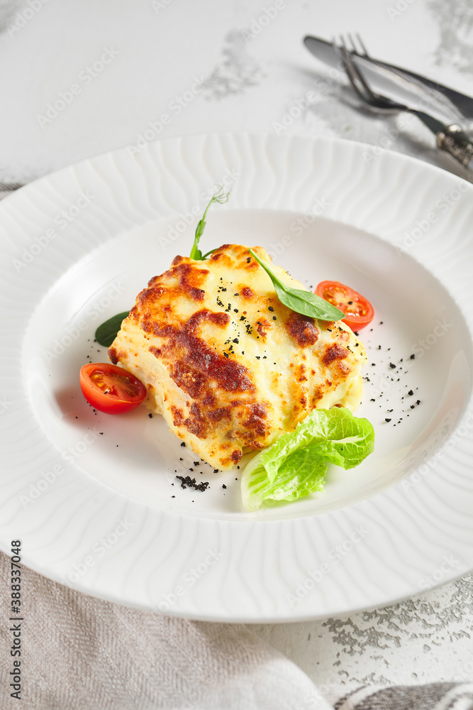 Lasagna with tomato and green leaf