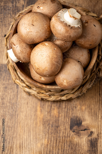 Aerial view of portobello mushrooms on wooden table, vertical, with copy space photo