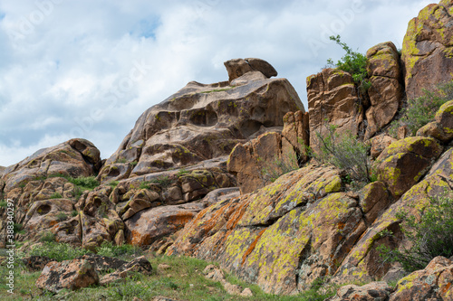 With whimsical red granite stone rocks. Spring. Almaty region, Kazakhstan. photo